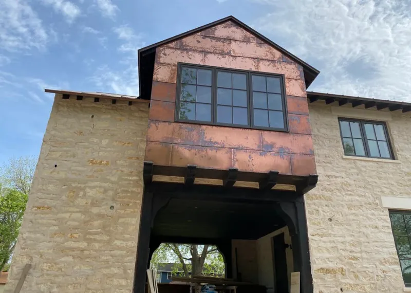 Copper metal panel facade on a stone building for Roof Repair in South Ogden